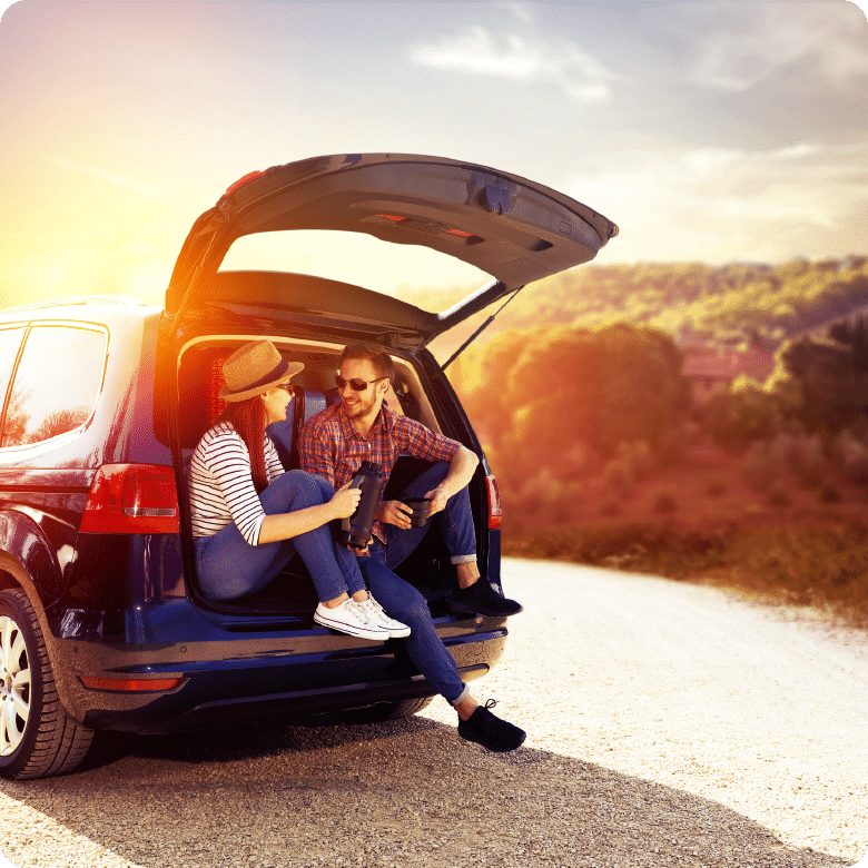 Family Sitting in Car Trunk