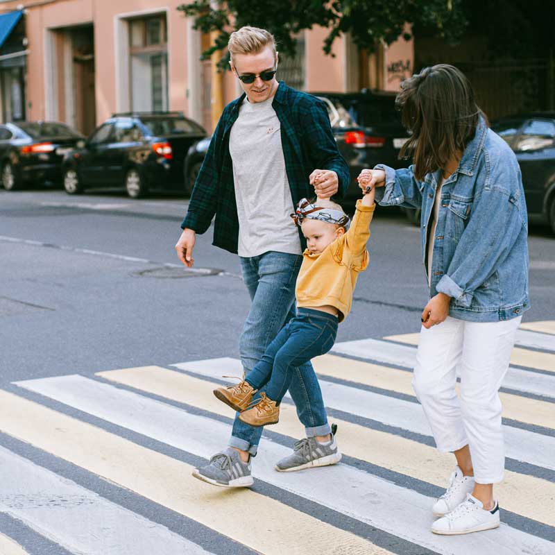 A family crossing the street.
